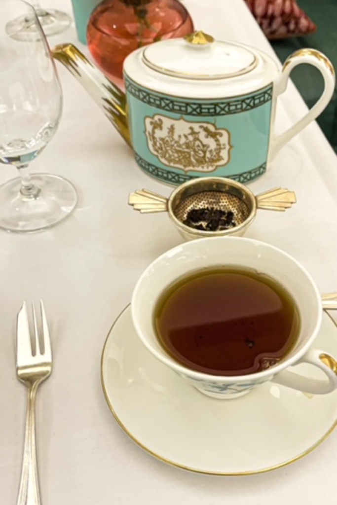 Afternoon tea.  White tea cup and blue tea pot