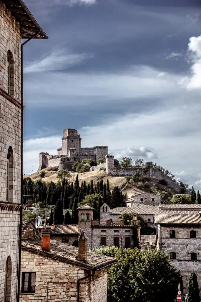 City on a hill.  Buildings appear to be old and rustic