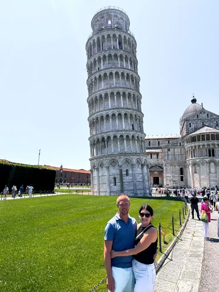 Woman and man taking picture in front of the leaning tower of Pisa