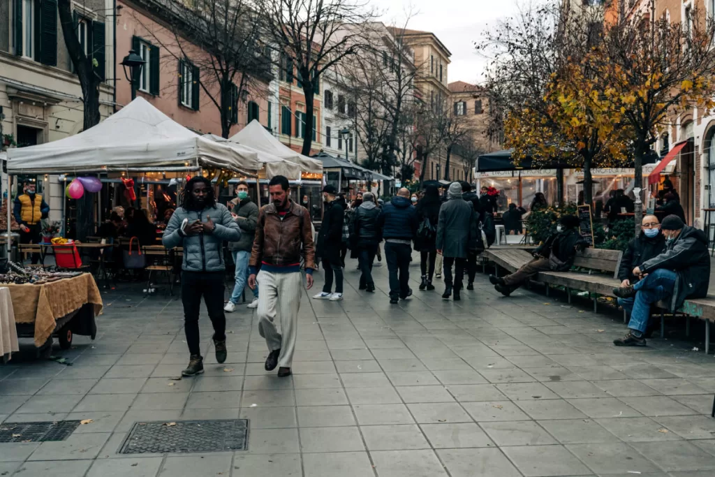 Market in outdoor rome.  Tents set up with people walking and talking