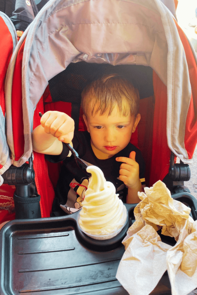 Kid eating icecream in stroller