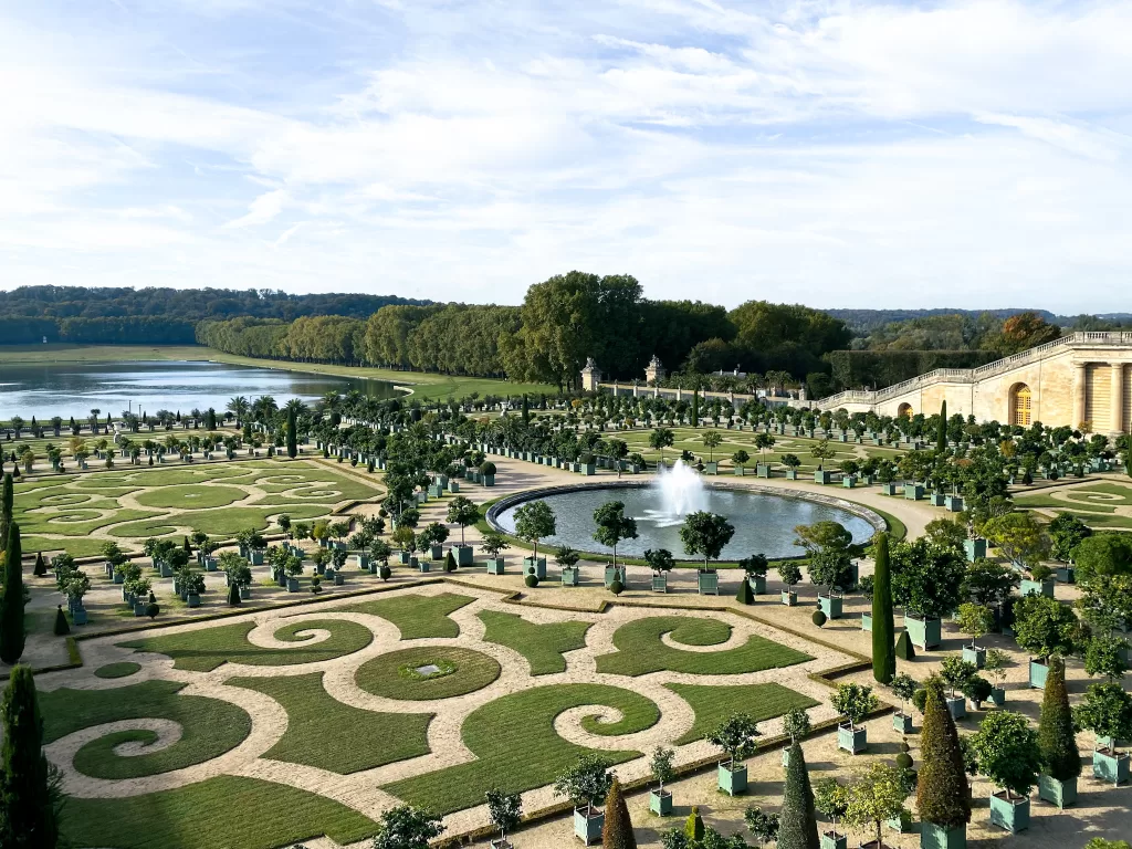 Large beautiful garden with topiaries and winding paths at the Palace of Versailles. 