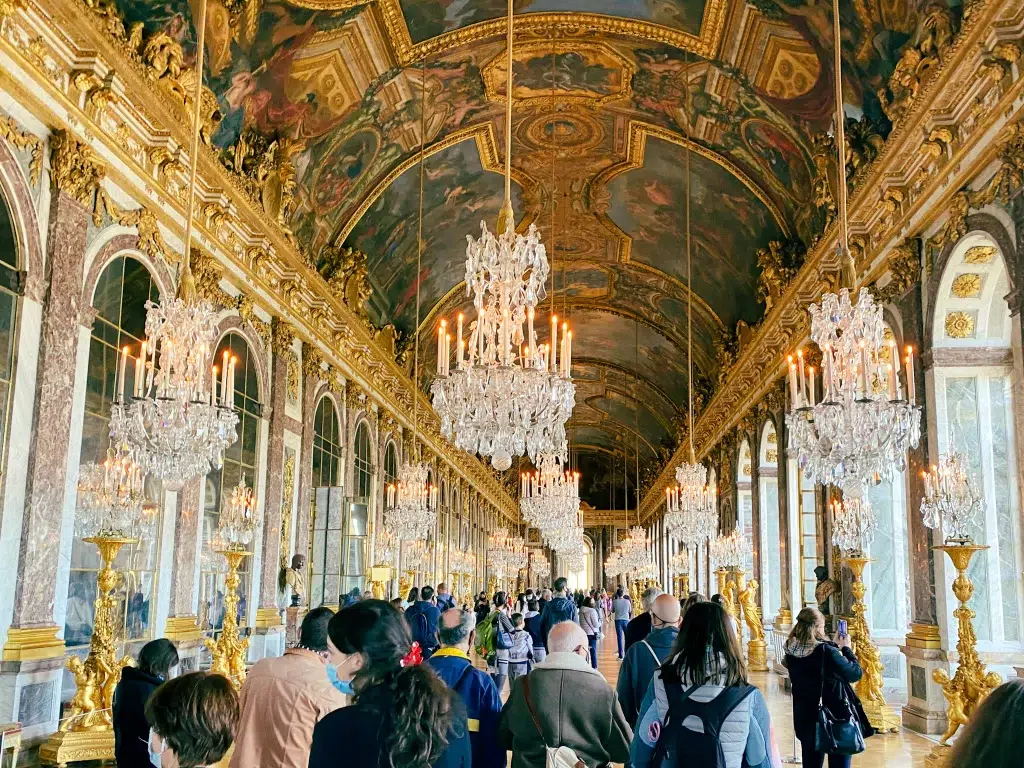 Hall of Mirrors at Versailles.  Long corridor with chandeliers 