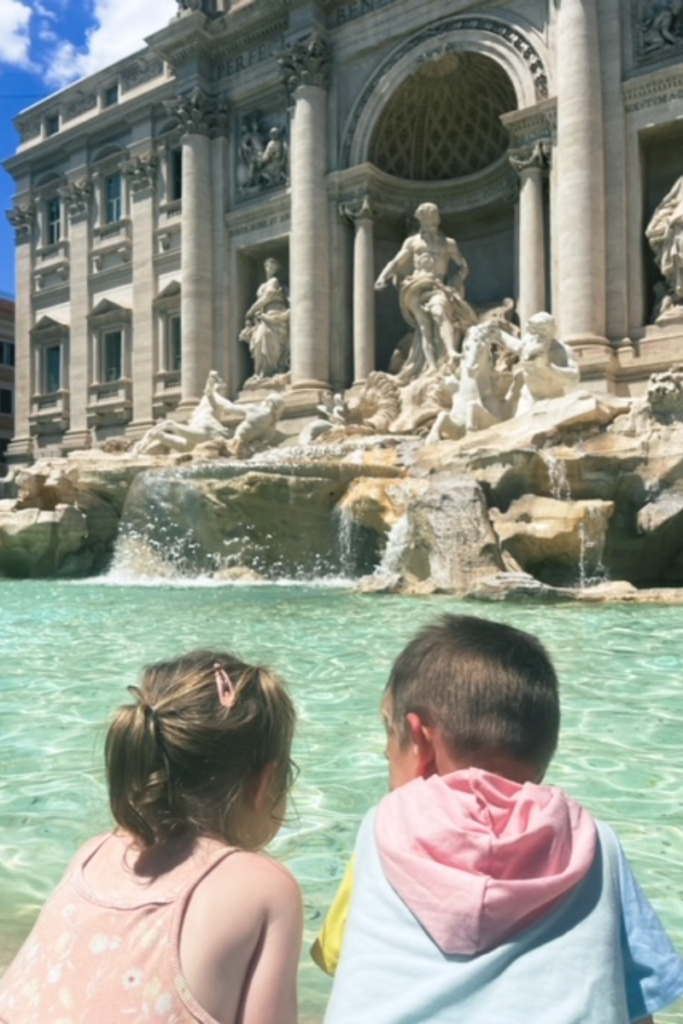 Two Kids looking at Trevi Fountain