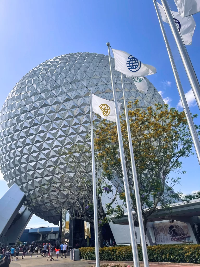 Spaceship Earth, the big ball at epcot with flags waving in the wind at Disney world