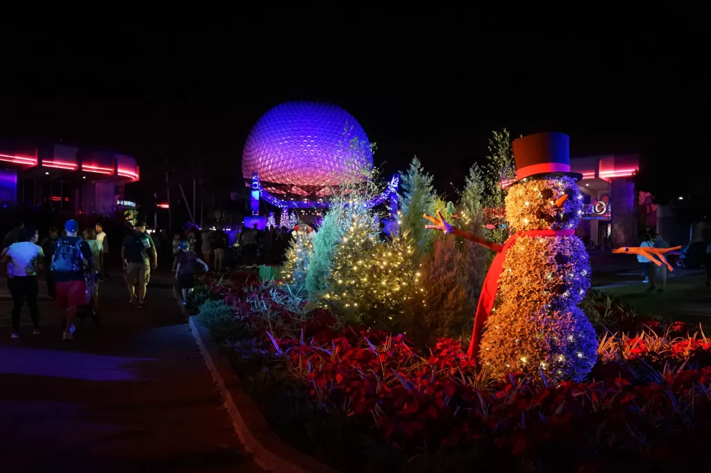 Snowman figurine in front of Epcot spaceship earth