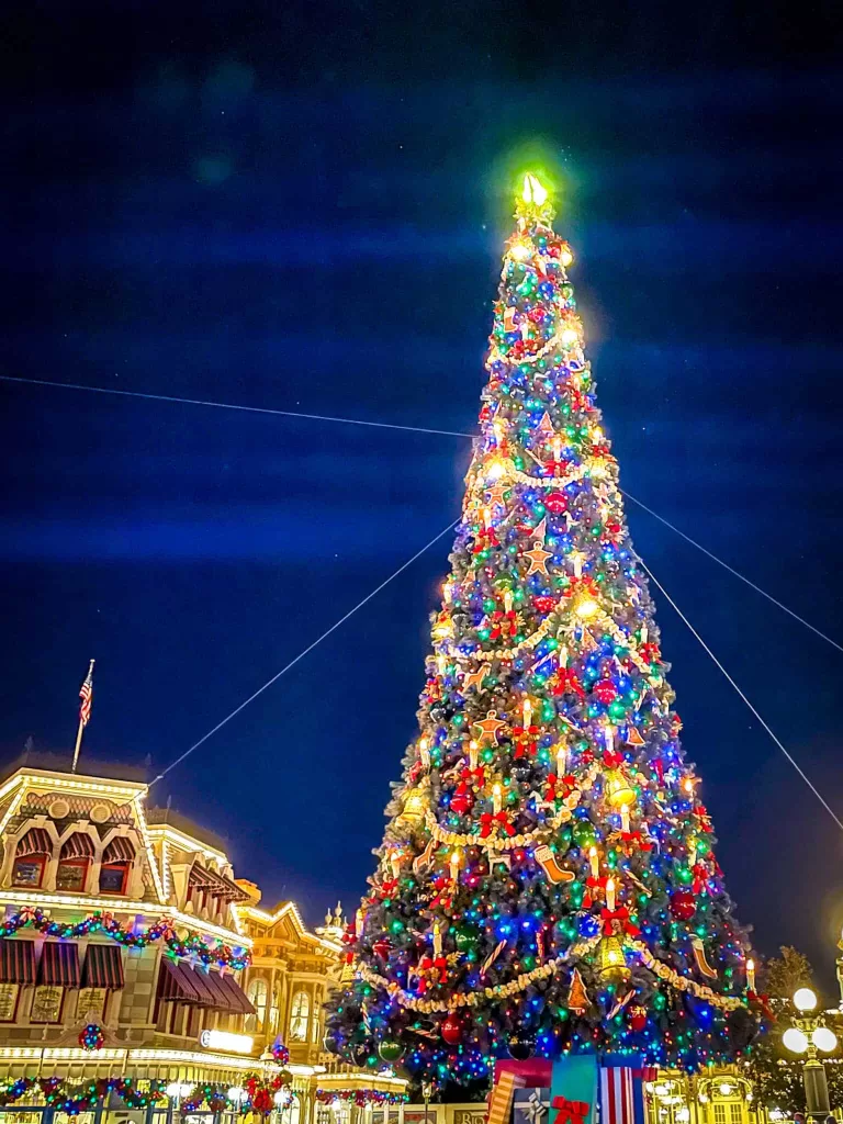 What to wear to Disney World in December. Christmas tree lit up on main street at Disney world