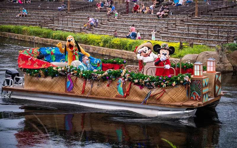 Boat with Mickey Mouse riding on it in his christmas santa attire