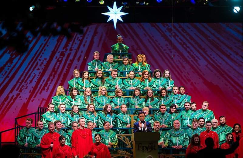 Choral singers at Epcot.  They are wearing green robes and singing