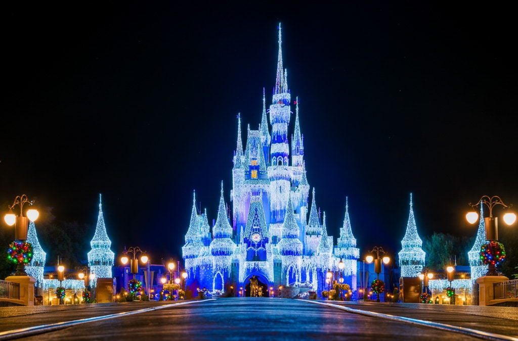 Cinderellas castle lit up un icy blue christmas lights.  What to wear at Disney World in December