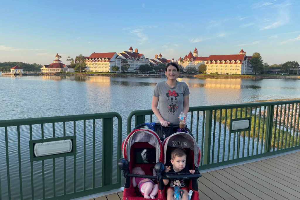 Mom standing with stroller at Disney world with kids.  Grand Floridian in the background