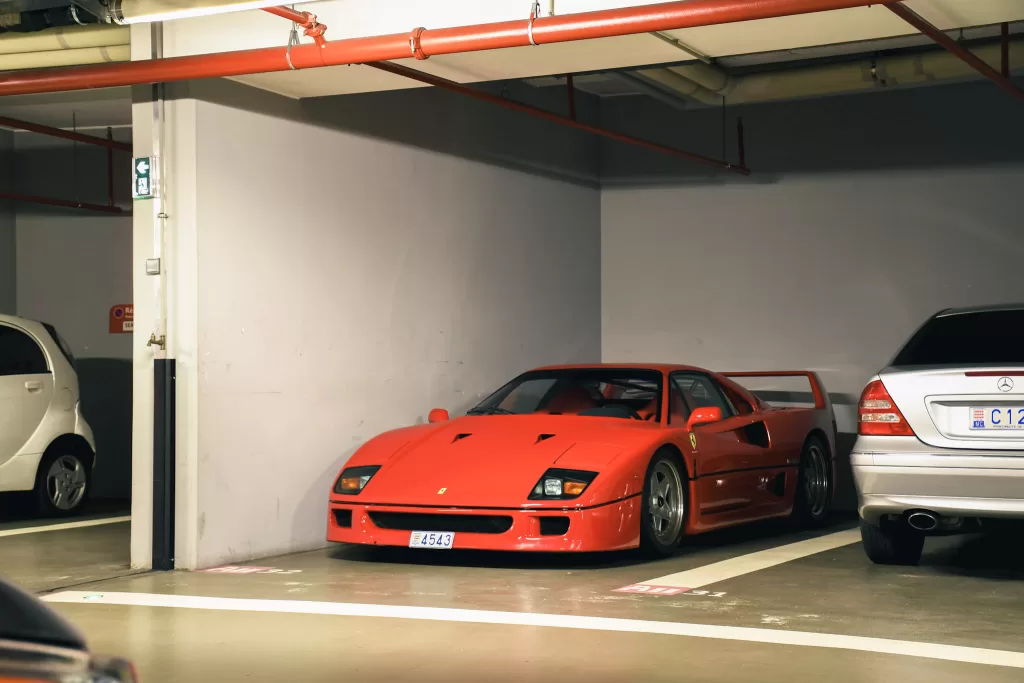 Red sports car in a parking garage.  