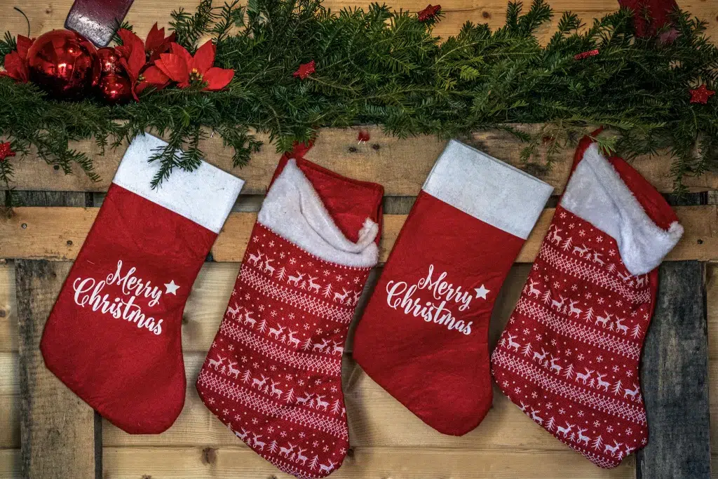 Red Stockings Hanging on a Mantel.  Christmas away from Home. 