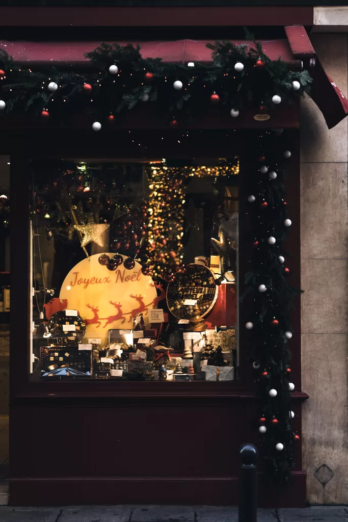 Window display with christmas lights and christmas wooden goods 