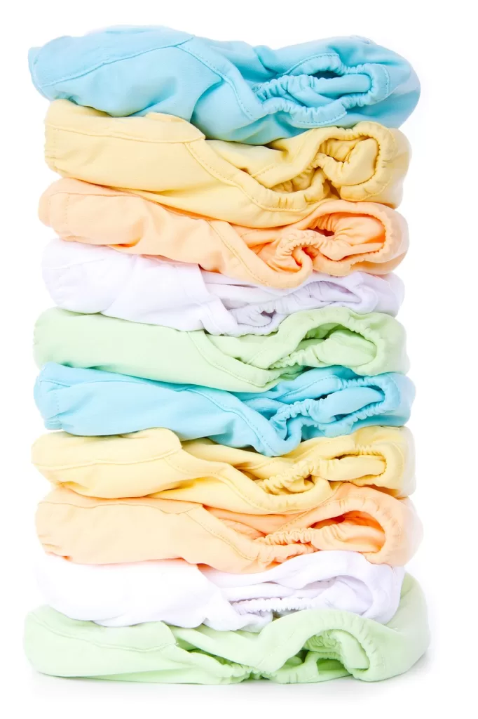 Pile of cloth diapers that are a range of colors. 