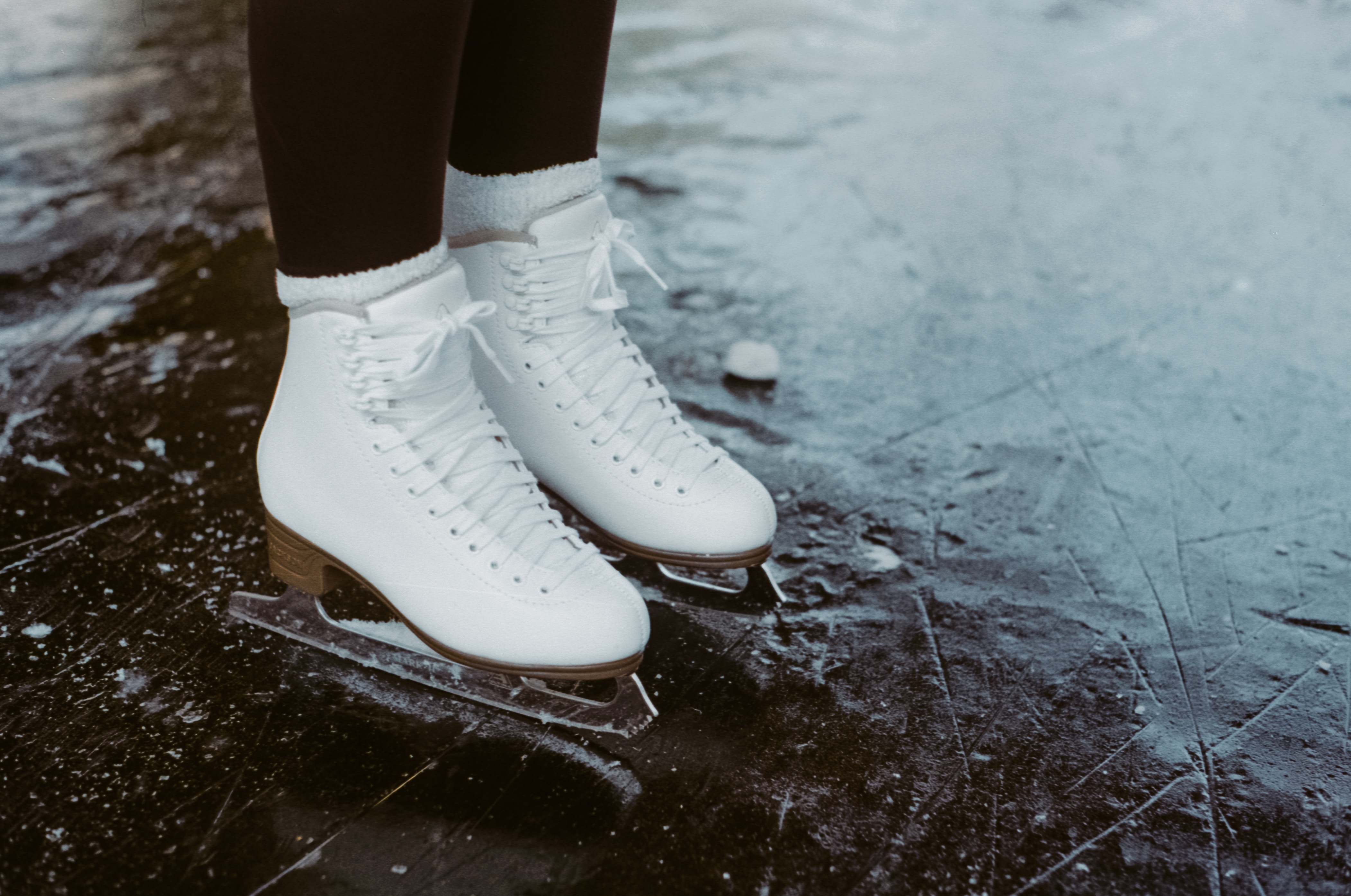 White ice skates on a slick ice rink
