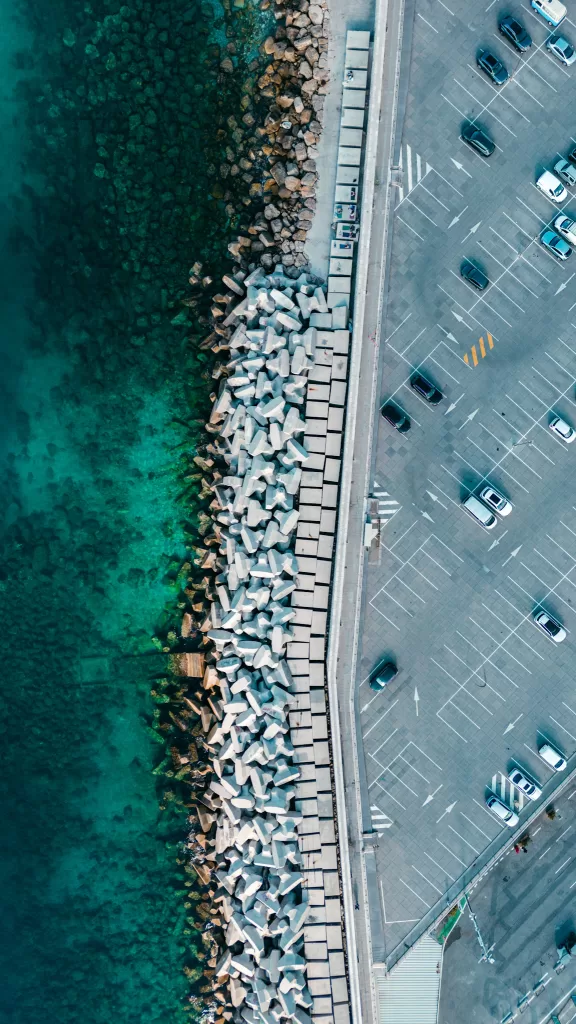 Parking Lot next to the ocean in Nice France.  Blue ocean and grey asphalt from an aerial perspective