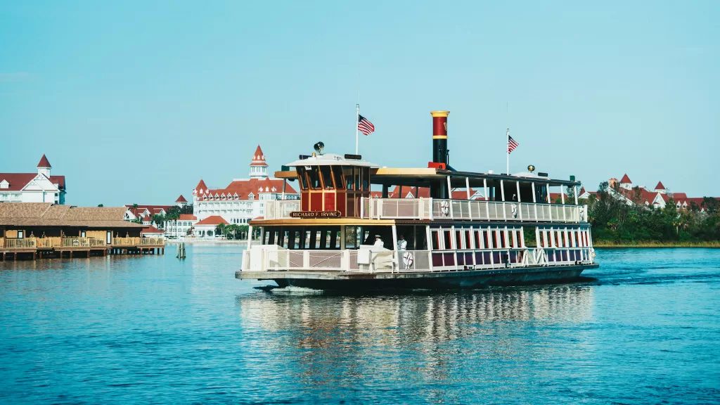 Ferry boat at Disney world crossing a blue lagoon.  Magic Kingdom Drop Off