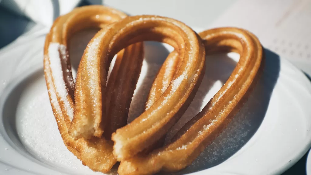 Lightly browned churros in a U shape