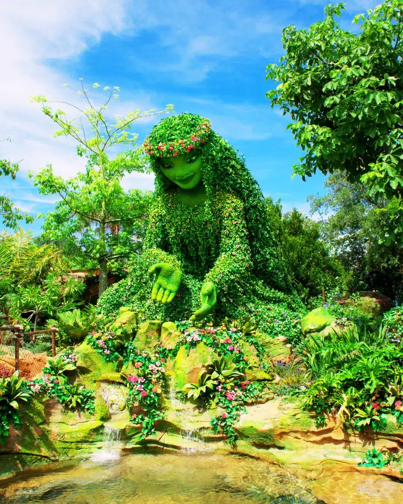 Moana Maic of water exibit at epcot. Large green statue of a women covered in leaves and plants