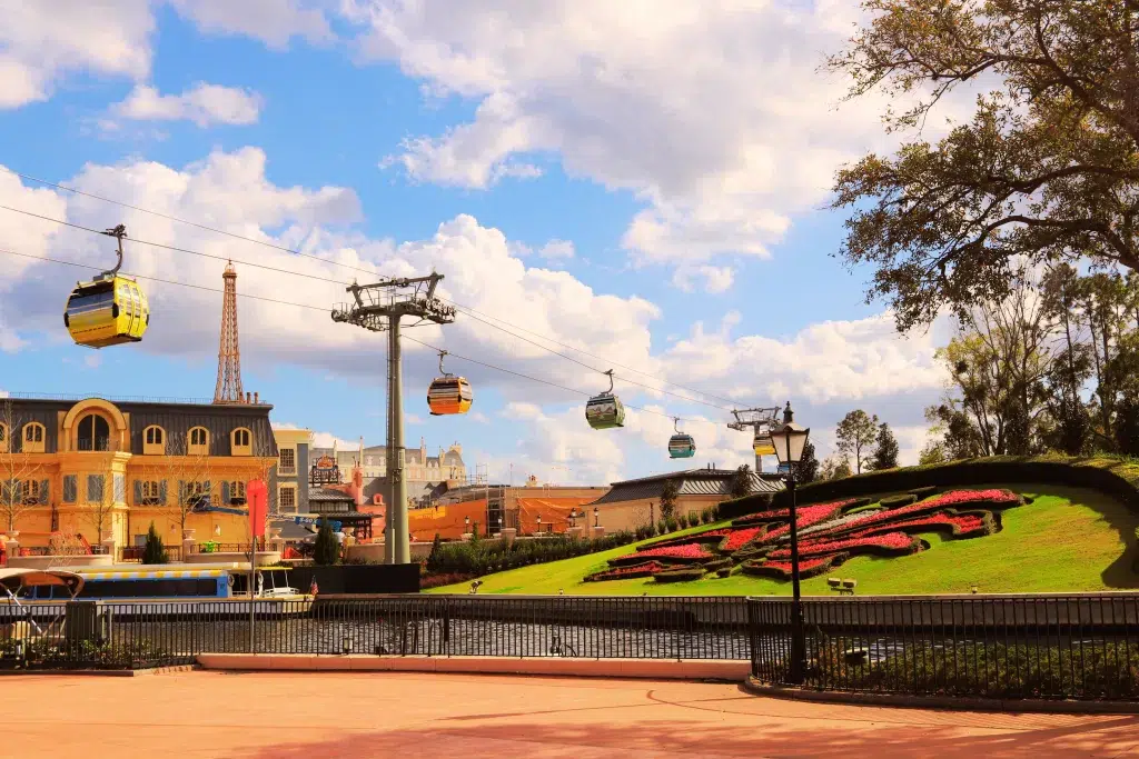 Large gondolas in bright colors in the air at Disney WOrld.  Hollywood studios vs epcot