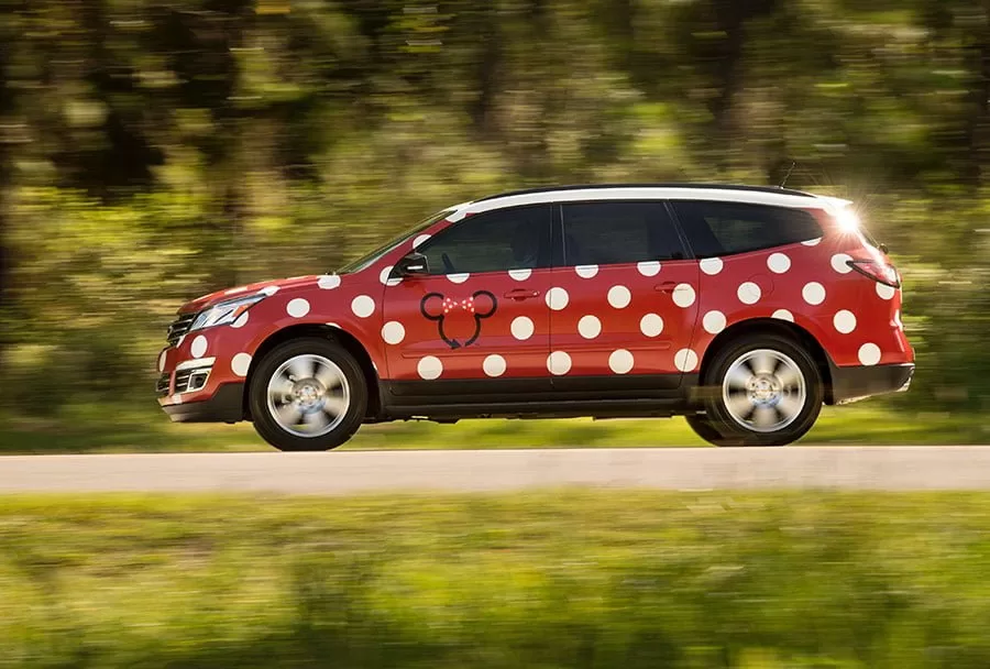 Car with a red and white paint job to mimick Minnie Mouse's dress.  Minnie van at walt Disney world