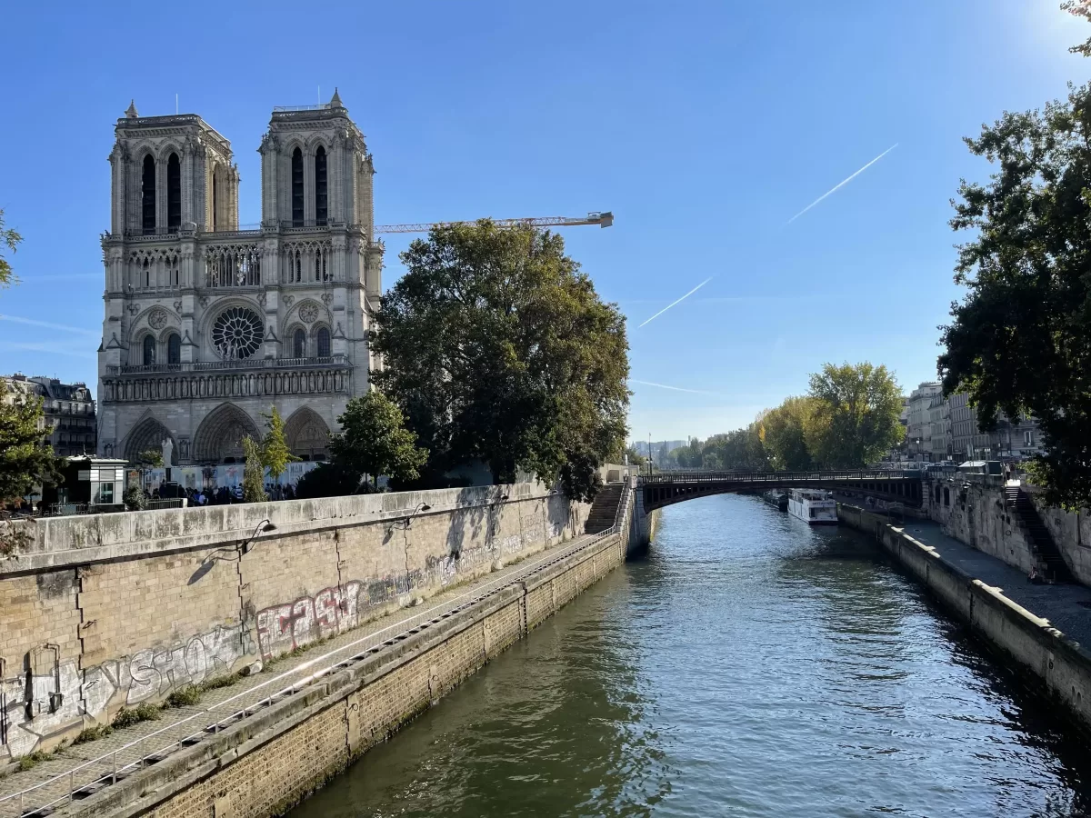 Seine river running along side a beautiful church, Notre Dame in Paris