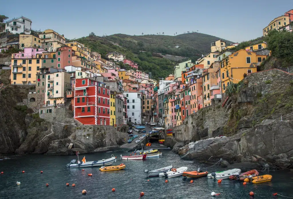 Harbor in cinque terre region of italy. Boats in harbor with colorful buildings in background