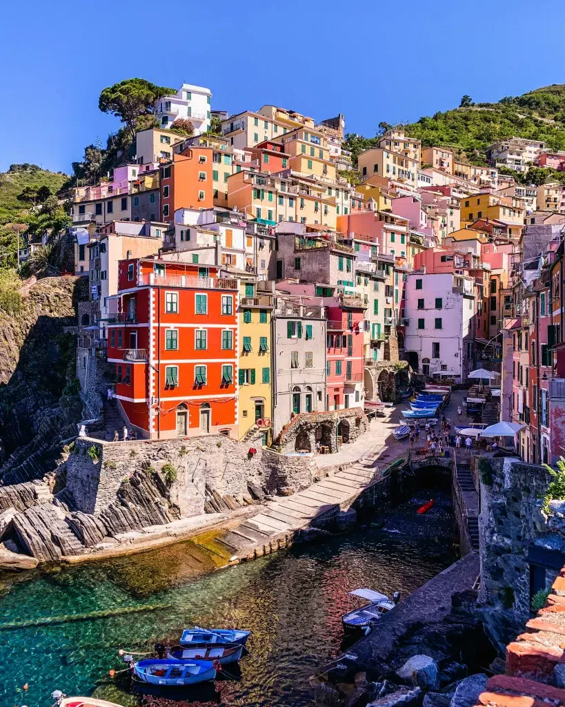 Red, yellow, pink buildings on the coast in italy.