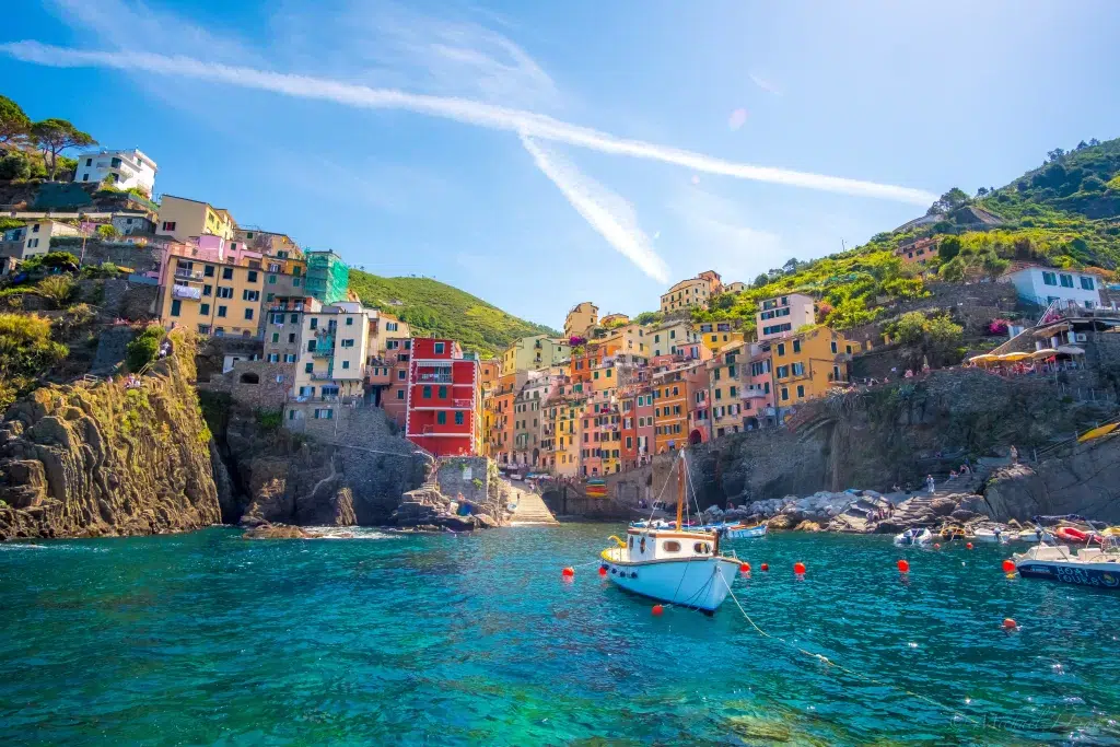 Colorful houses on side of hill on shoreline in italy