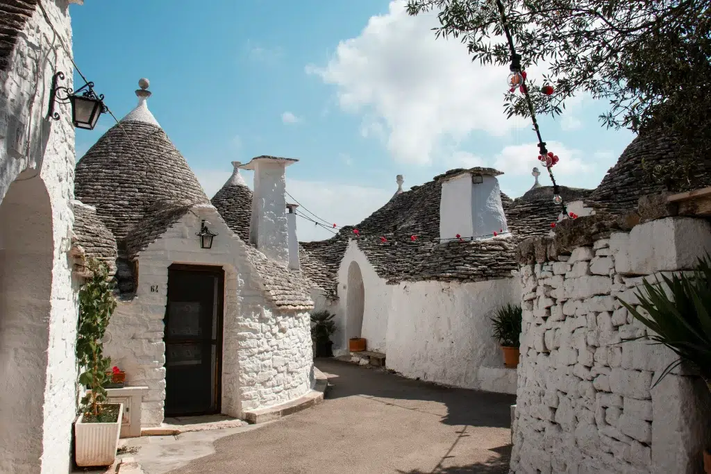 White, round houses with pointed roofs in Puglia, Italy