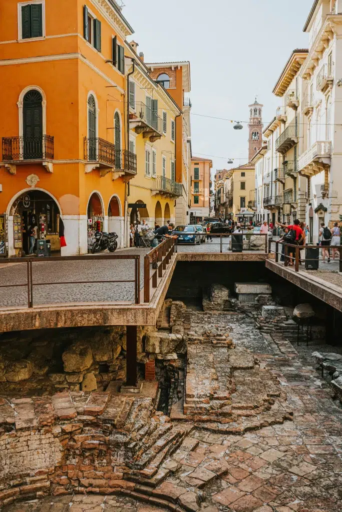 Yellow and tan buidlings lined on a cobblestone street in Verona, Italy