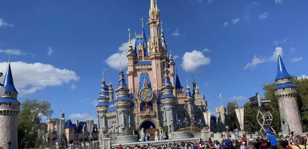 Iconic blue and pink castle at disney world.  What to wear to disney world in july