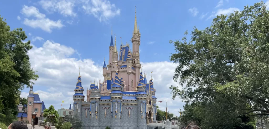 Iconic Pink and Blue castle at Disney World.  What to wear to disney world in july