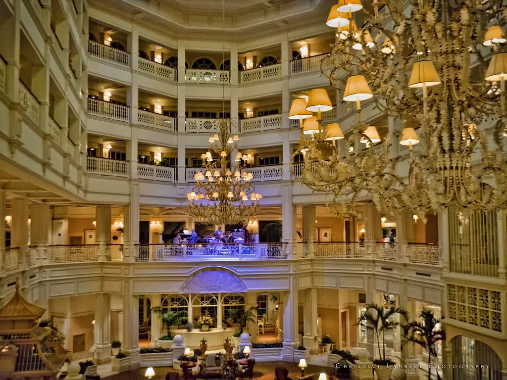 Evening time at the grand floridian resort.  The lobby is lit in yellow lights