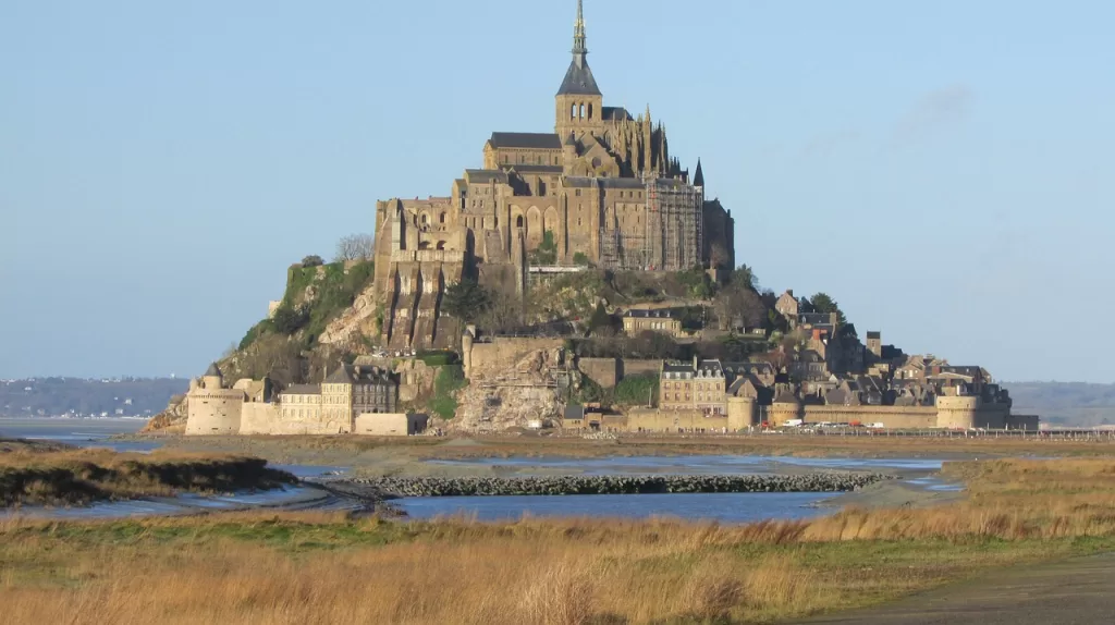 Mont St Michel fortress in the background with water surrounding it in the forground., france, normandy, island