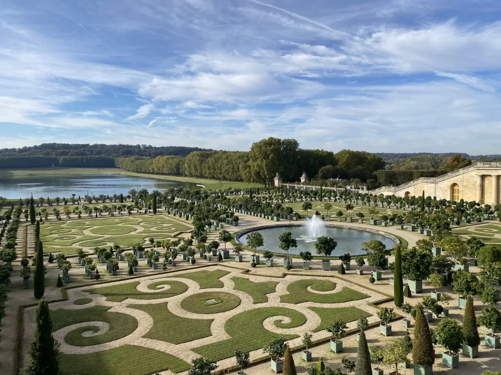 intricate pathways and fountains in a beautiful pattern at the palace of versailles.