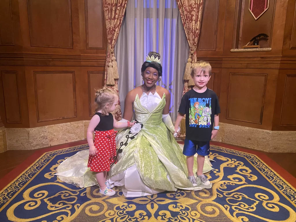 Two young children posing with character, Tiana from Princess and the frog at walt disney world