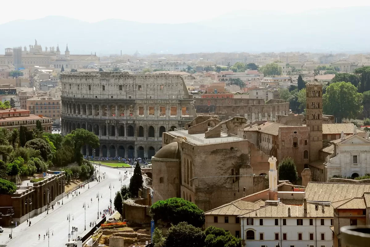 aerial view of city buildings during daytime. Colosseum Rome