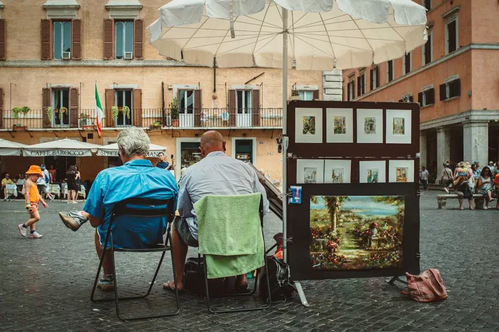 man in blue shirt sitting on black and gray wheelchair in the piazza navona