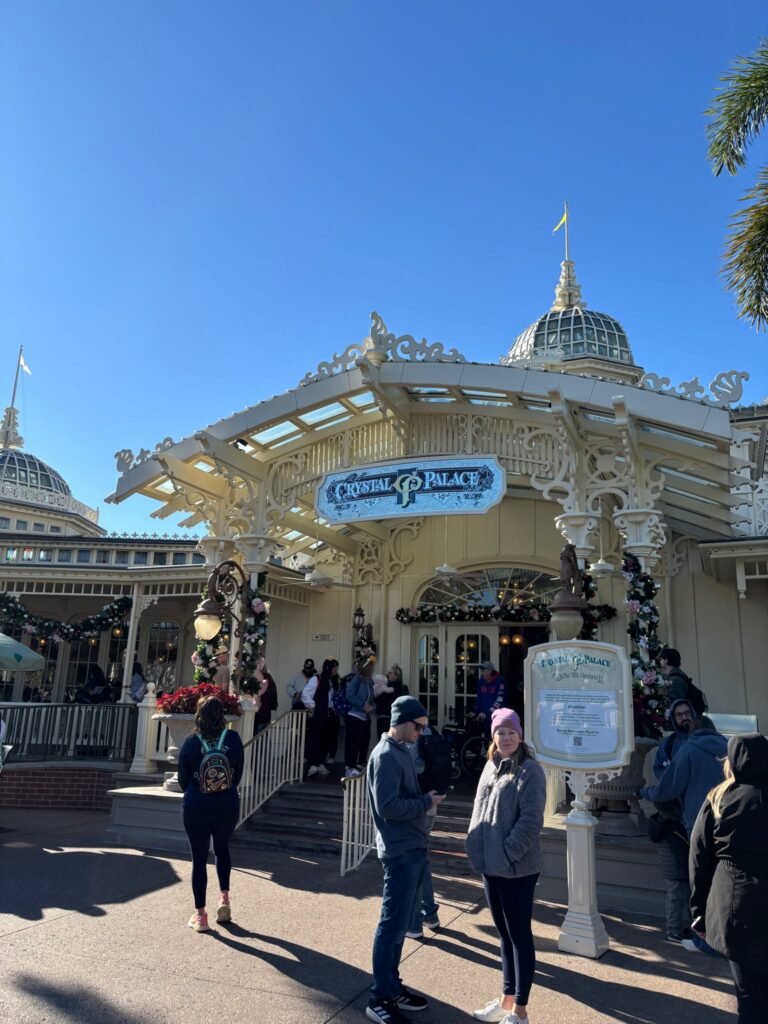Victorian looking building with a sign that says crystal palace.  At disney world